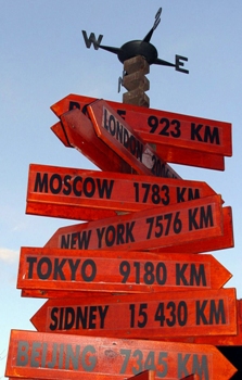 Featured is a world destination/mileage signpost ... not exactly sure of its location.  Can someone tell us?